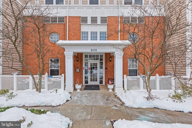 view of snow covered property entrance