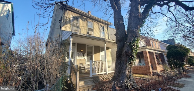 view of side of home featuring a porch