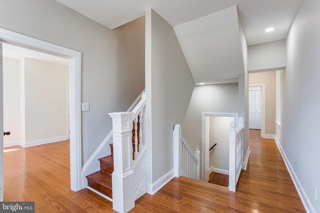 stairs with hardwood / wood-style flooring