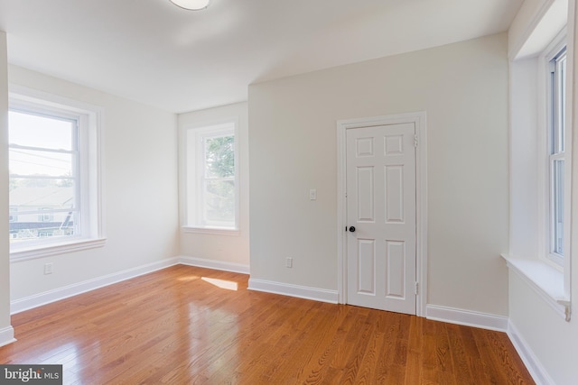 unfurnished room featuring light hardwood / wood-style floors