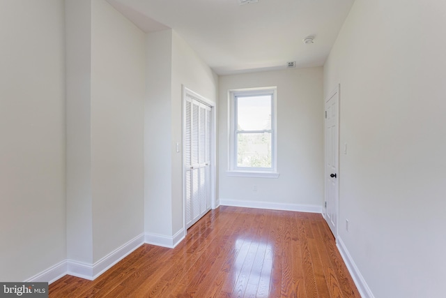 unfurnished room with wood-type flooring