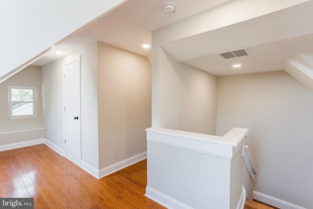 hall with hardwood / wood-style flooring