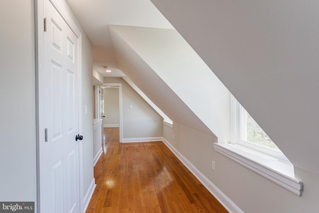 additional living space featuring hardwood / wood-style floors and vaulted ceiling