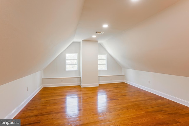 bonus room featuring lofted ceiling and light hardwood / wood-style flooring