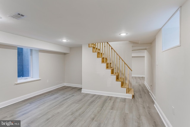 basement featuring light wood-type flooring