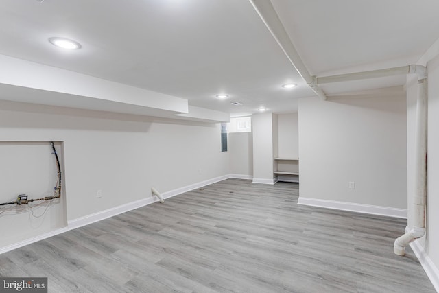 basement featuring light wood-type flooring