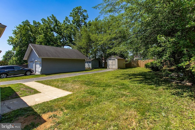 view of yard with a garage and a storage unit