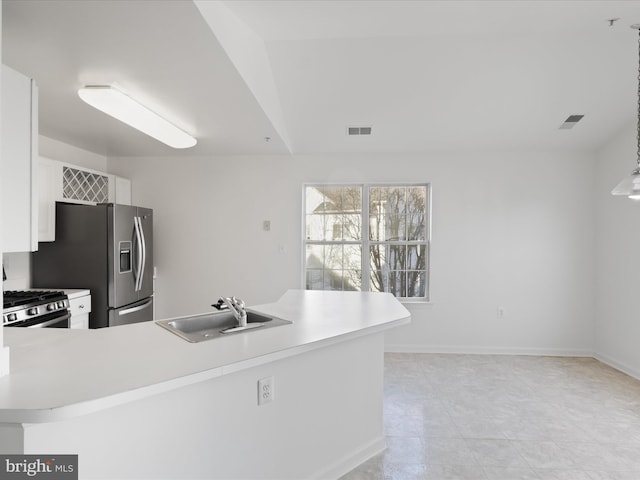 kitchen featuring stainless steel appliances, sink, white cabinets, and kitchen peninsula