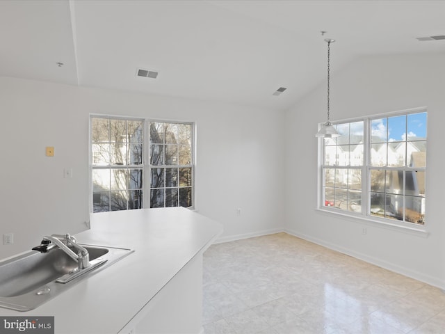 dining space featuring lofted ceiling and sink