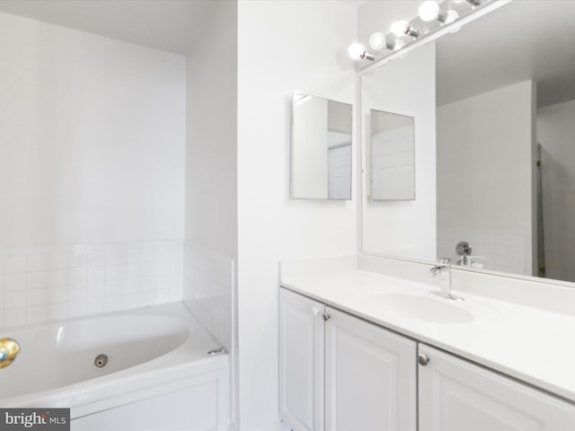 bathroom featuring vanity and a washtub