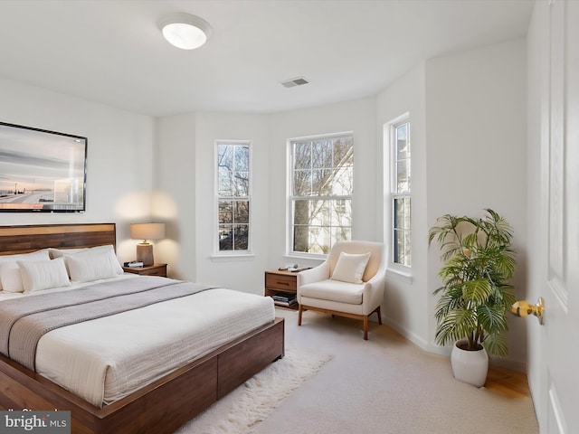 bedroom featuring light carpet