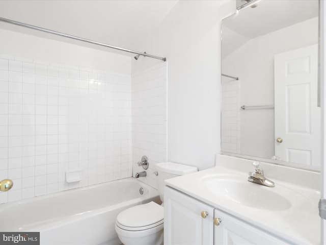 full bathroom with vanity, tiled shower / bath combo, and toilet