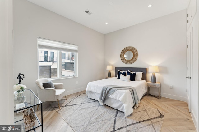 bedroom with light parquet floors