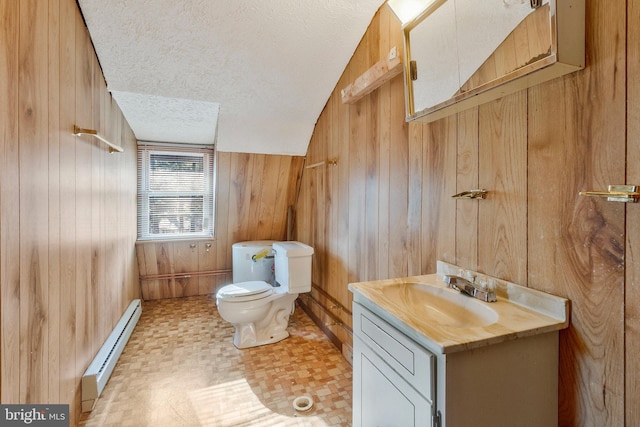 bathroom featuring baseboard heating, a textured ceiling, toilet, wooden walls, and vanity