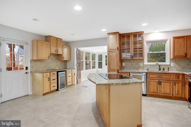 kitchen featuring sink, dishwasher, a center island, beverage cooler, and black electric stovetop