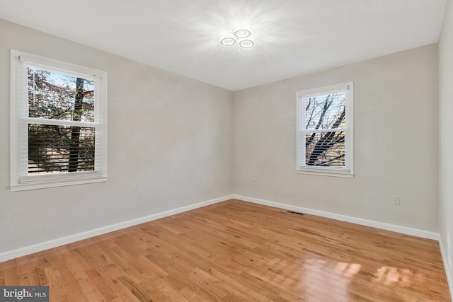 spare room featuring light hardwood / wood-style floors