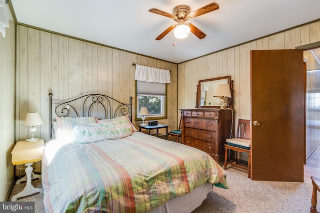 bedroom with crown molding, light colored carpet, and ceiling fan