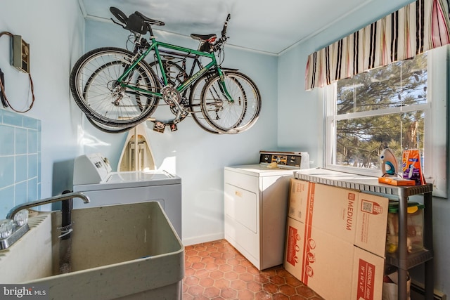 laundry area featuring tile patterned floors, sink, and washing machine and dryer