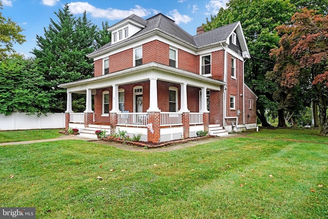 view of front of house with covered porch and a front yard