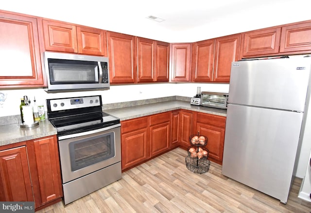 kitchen featuring appliances with stainless steel finishes and light wood-type flooring