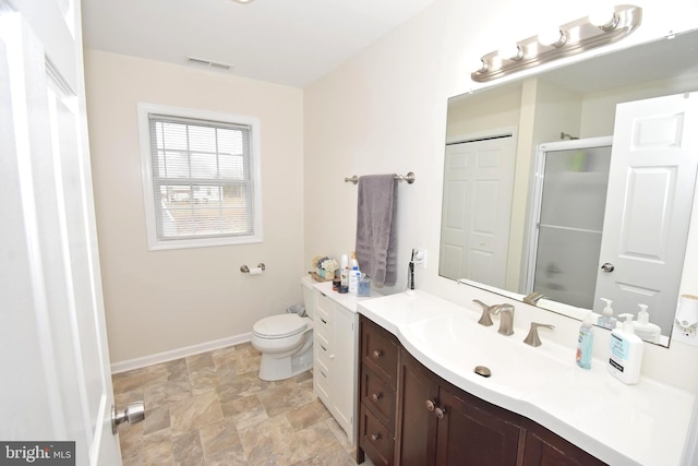 bathroom with vanity, toilet, and an enclosed shower