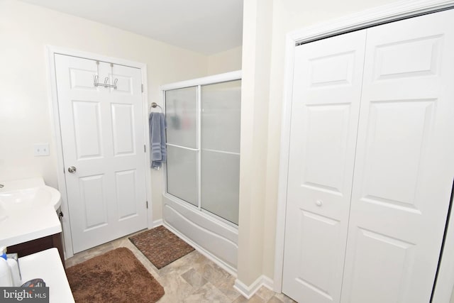 bathroom featuring vanity and bath / shower combo with glass door