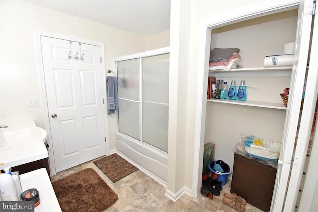 bathroom with vanity and shower / bath combination with glass door