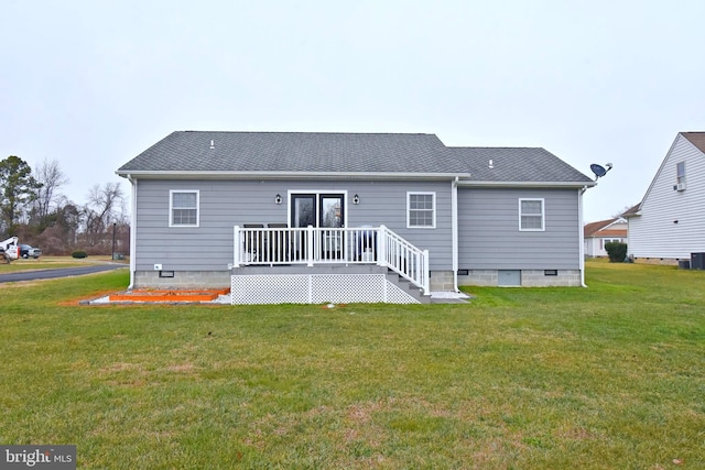 rear view of property with a lawn, cooling unit, and a deck