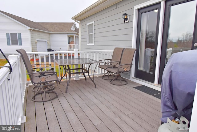 wooden terrace featuring a grill