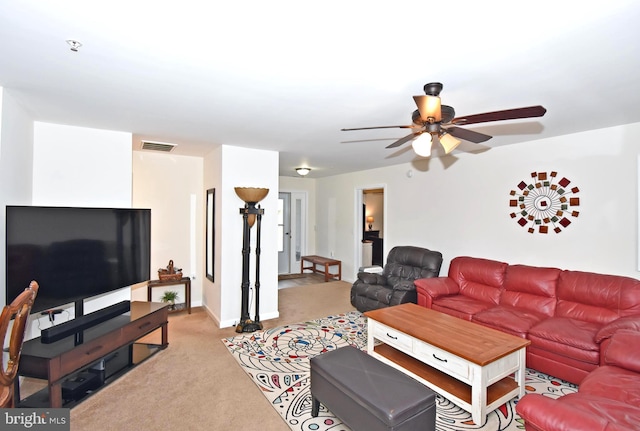 living room featuring light carpet and ceiling fan