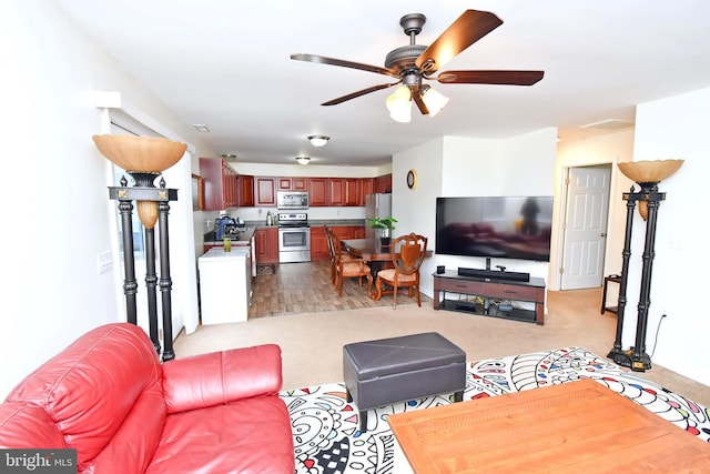 carpeted living room featuring ceiling fan