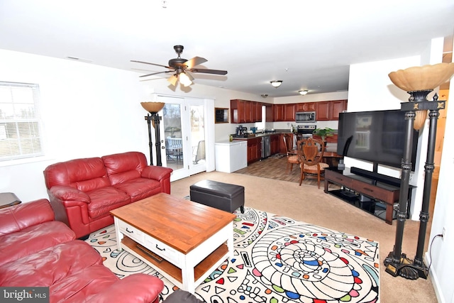 living room with ceiling fan and light carpet