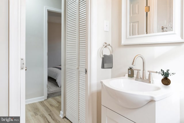 bathroom with vanity and hardwood / wood-style flooring