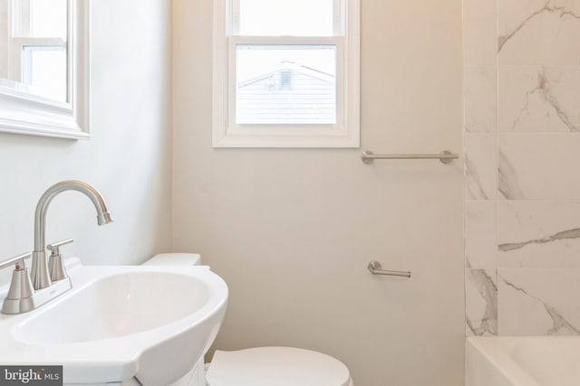 bathroom featuring sink, plenty of natural light, and toilet