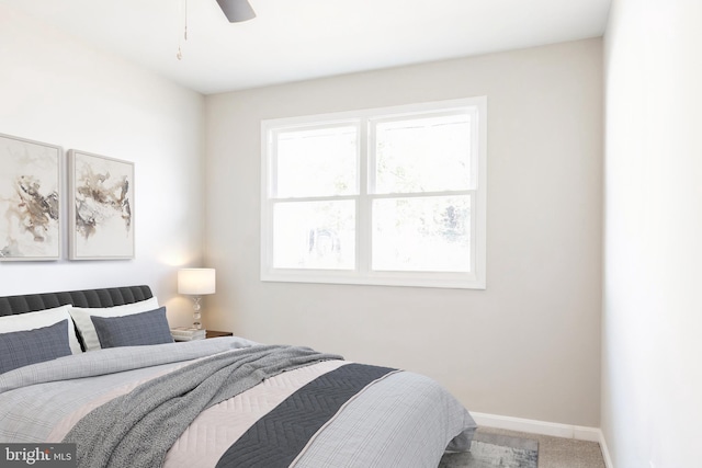 bedroom featuring ceiling fan and carpet