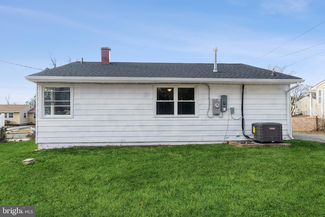 back of property featuring a yard and central AC unit