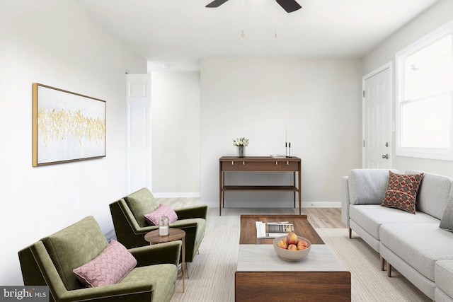 living room with ceiling fan and light hardwood / wood-style flooring