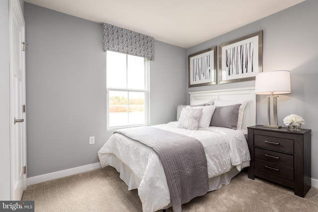 bedroom with light colored carpet