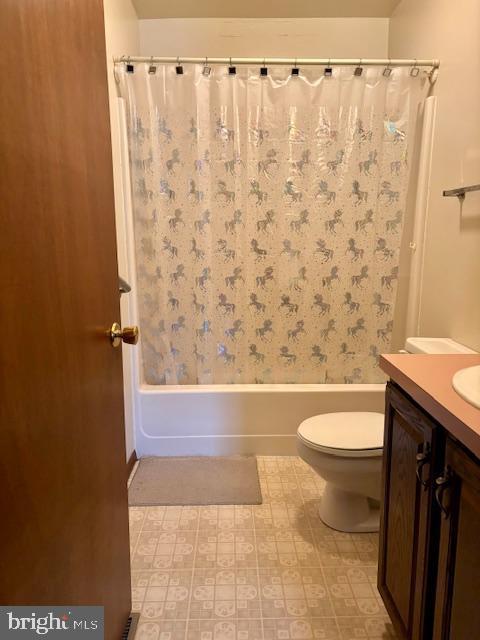 full bathroom featuring vanity, toilet, and shower / bathtub combination with curtain