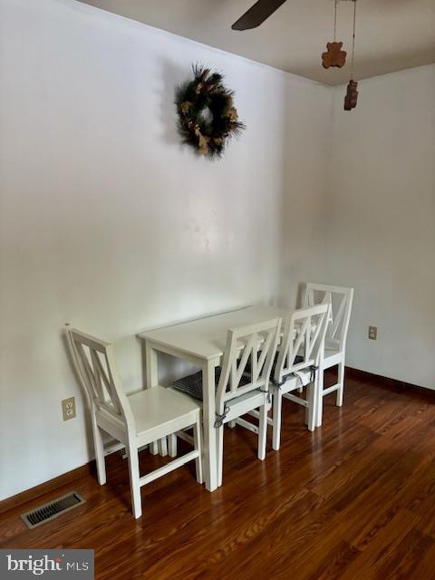 unfurnished dining area featuring dark hardwood / wood-style floors and ceiling fan