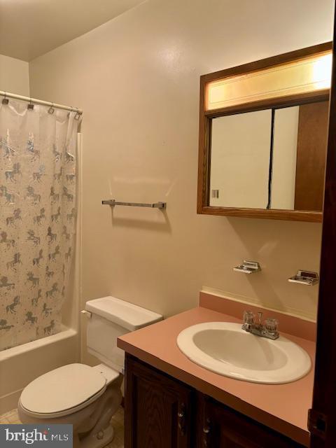 full bathroom with vanity, toilet, and shower / bath combo with shower curtain