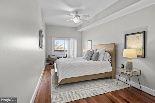 bedroom with ceiling fan and dark hardwood / wood-style floors