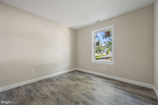 613 W 8th St, Laurel, DE 19956 - spare room featuring baseboards and dark wood-type flooring