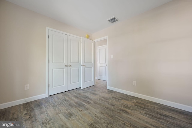 613 W 8th St, Laurel, DE 19956 - unfurnished bedroom featuring wood finished floors and a closet