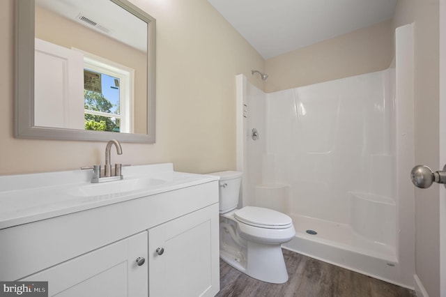 613 W 8th St, Laurel, DE 19956 - bathroom featuring wood finished floors, vanity, and a shower