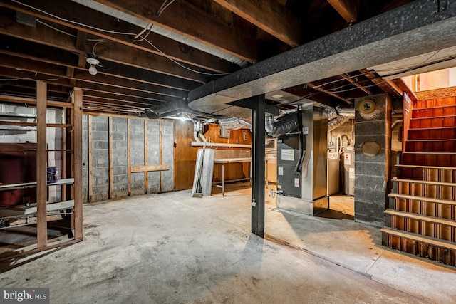 basement with water heater and heating unit