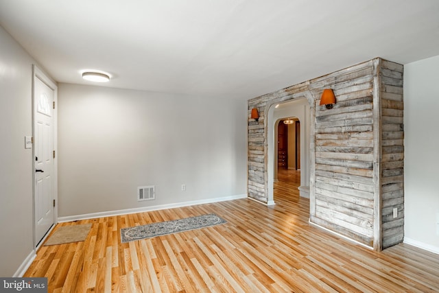 empty room with light hardwood / wood-style flooring