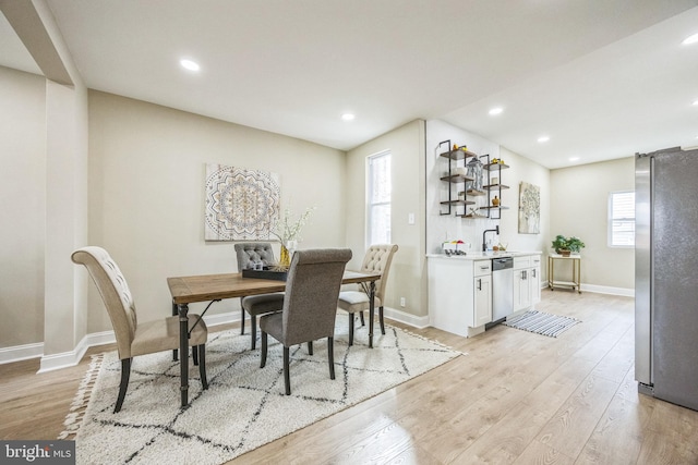 dining area featuring light hardwood / wood-style flooring and sink