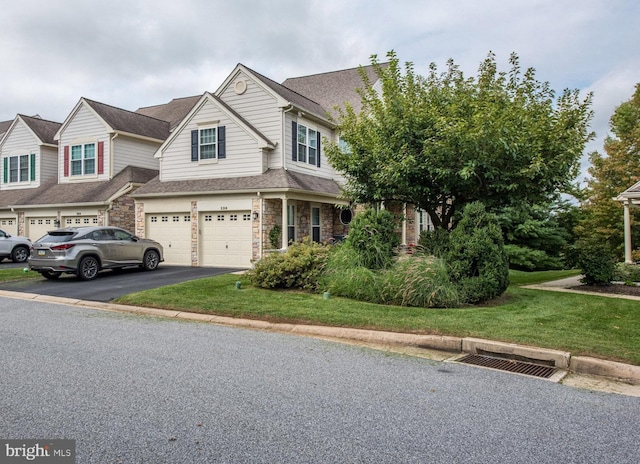 view of front of property featuring a front yard and a garage