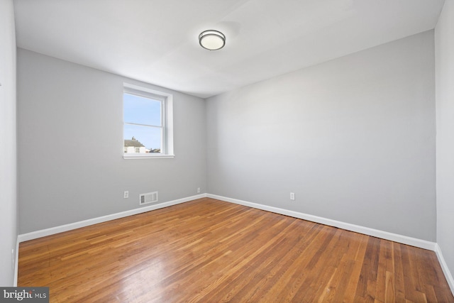 empty room featuring wood-type flooring